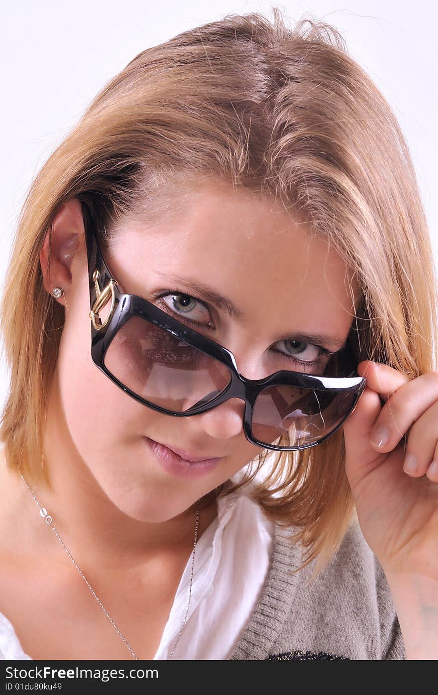 Young lady taking off sunglasses. Young lady taking off sunglasses