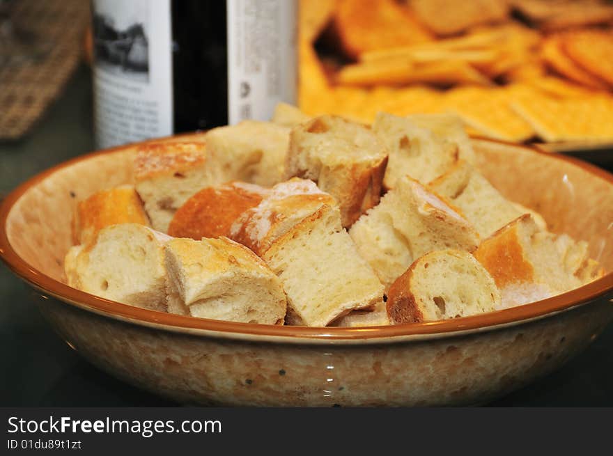 Bread as part of a meal with a bottle of wine in the background