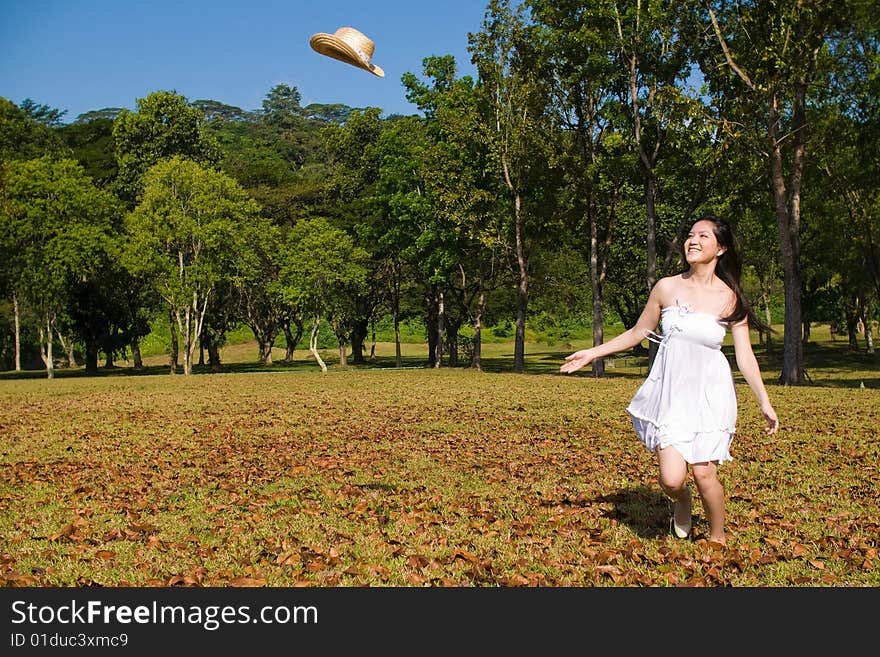 A beautiful asian girl enjoying the outdoor sun. A beautiful asian girl enjoying the outdoor sun