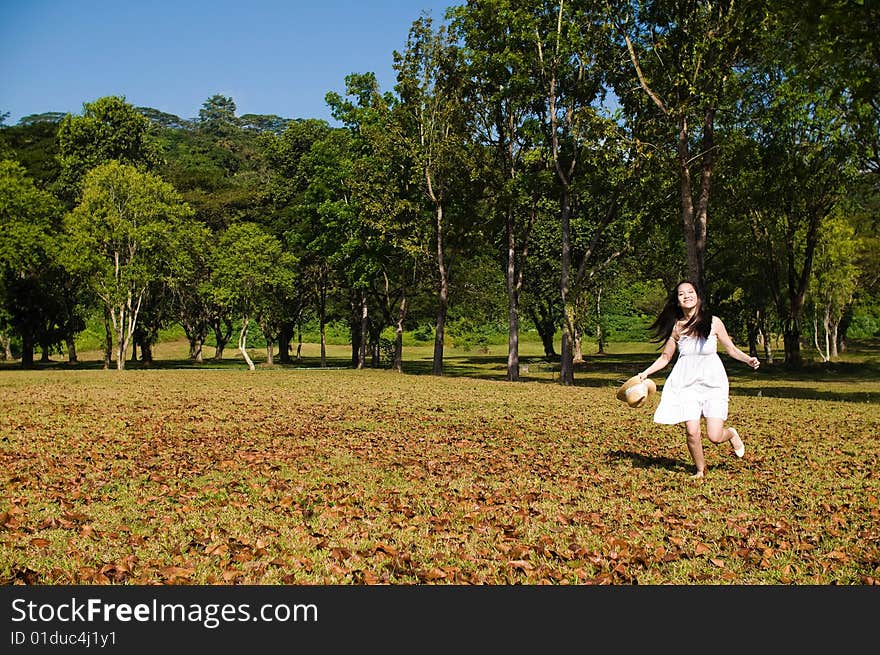 A beautiful asian girl enjoying the outdoor sun. A beautiful asian girl enjoying the outdoor sun