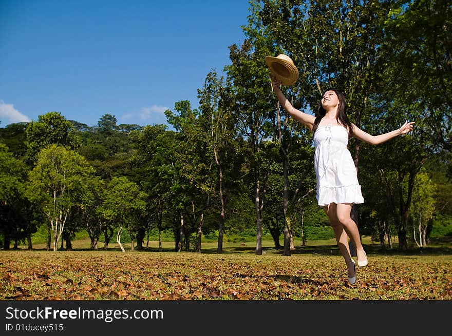 A beautiful asian girl enjoying the outdoor sun. A beautiful asian girl enjoying the outdoor sun