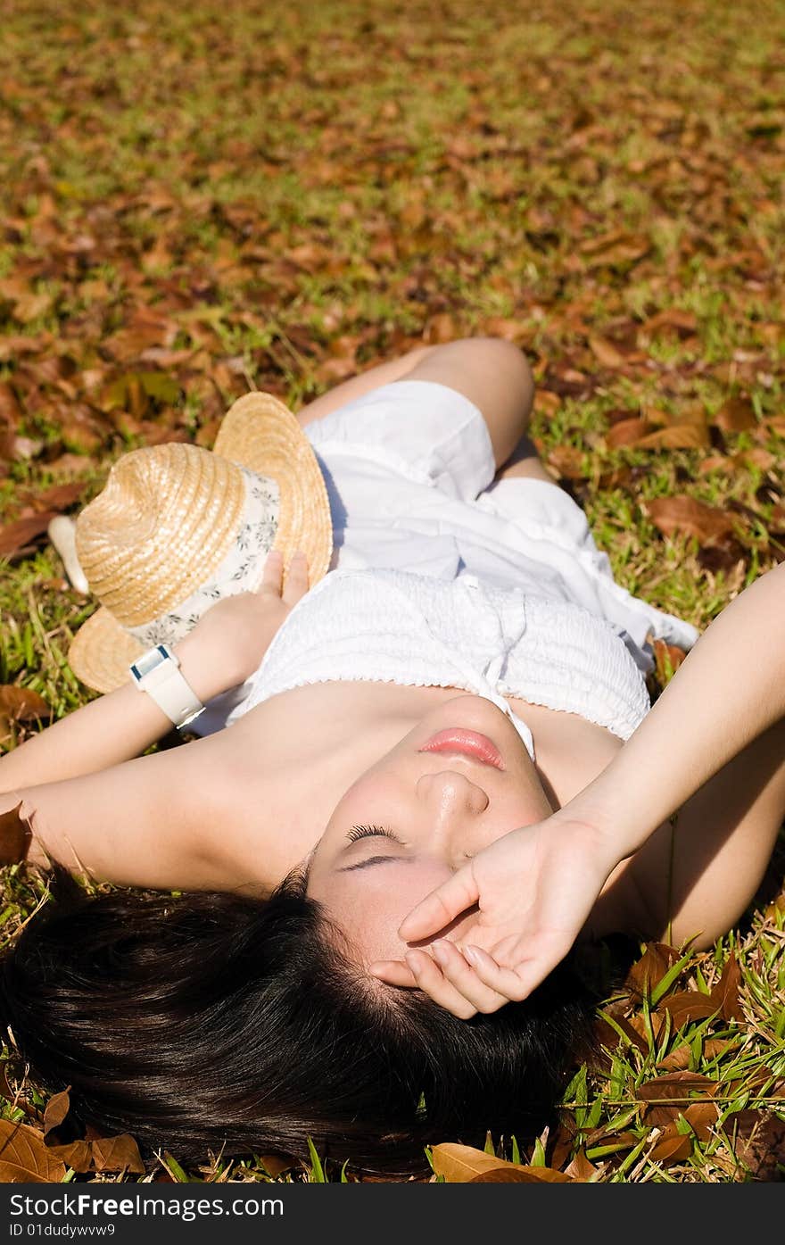 A beautiful asian girl enjoying the outdoor sun. A beautiful asian girl enjoying the outdoor sun