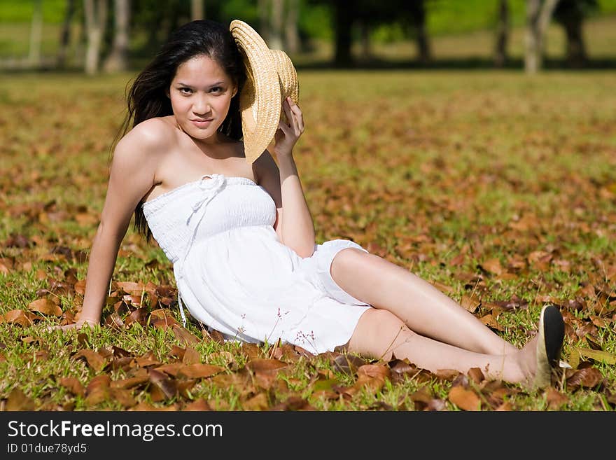 A beautiful asian girl enjoying the outdoor sun. A beautiful asian girl enjoying the outdoor sun