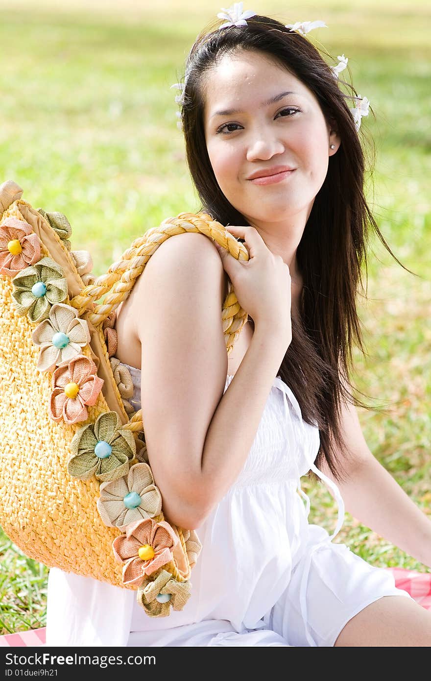 A beautiful asian girl enjoying the outdoor sun. A beautiful asian girl enjoying the outdoor sun