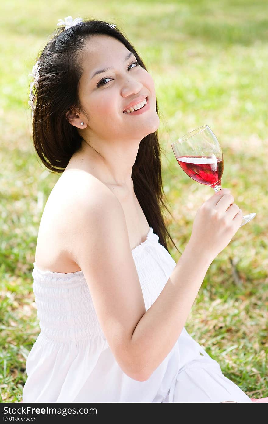 A beautiful asian girl enjoying the outdoor sun. A beautiful asian girl enjoying the outdoor sun