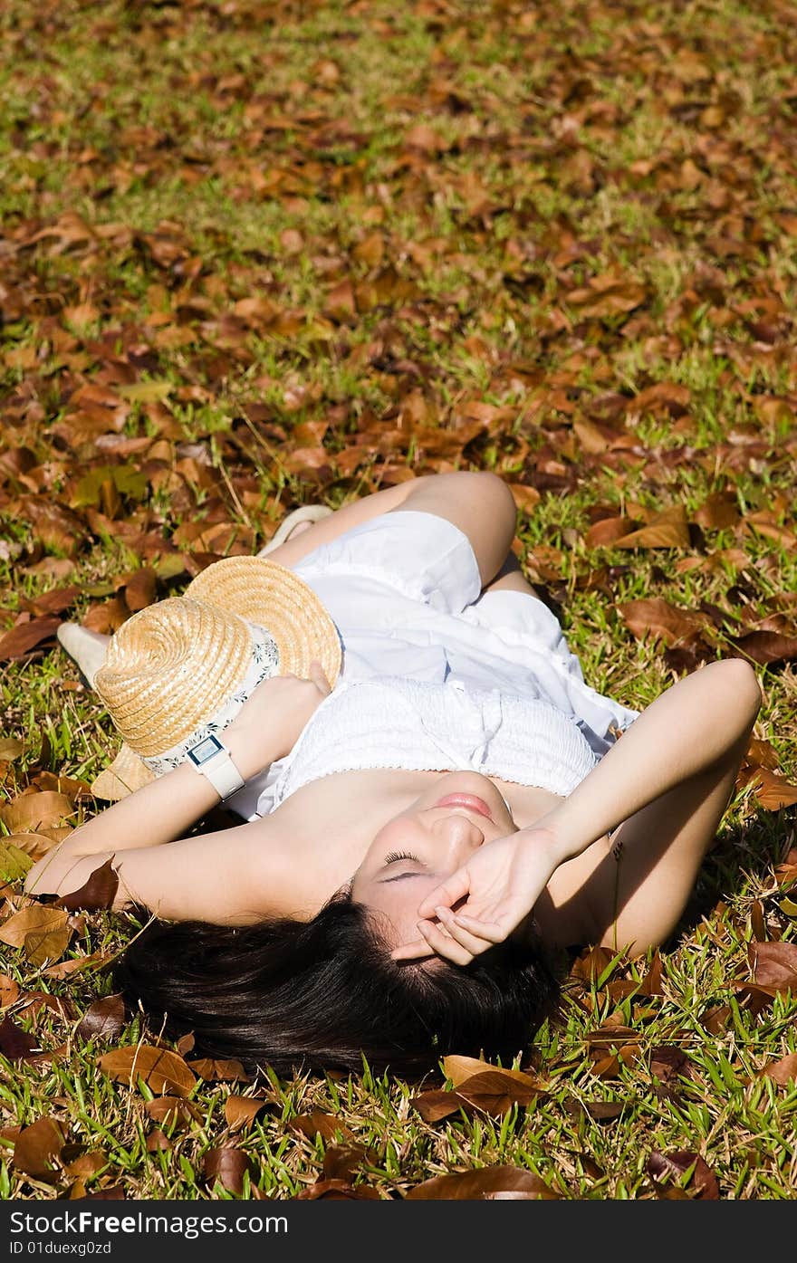 A beautiful asian girl enjoying the outdoor sun. A beautiful asian girl enjoying the outdoor sun