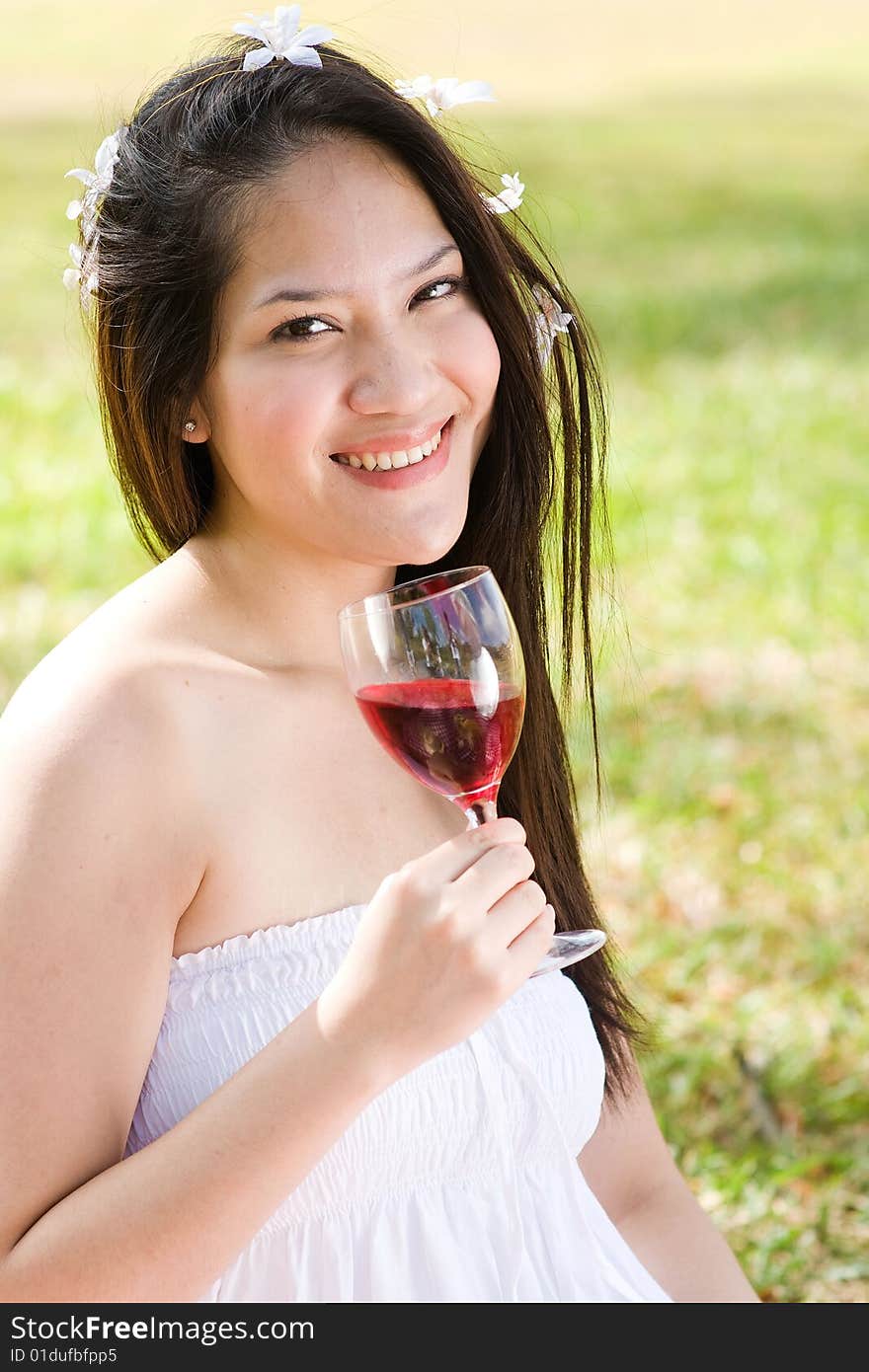 A beautiful asian girl enjoying the outdoor sun. A beautiful asian girl enjoying the outdoor sun