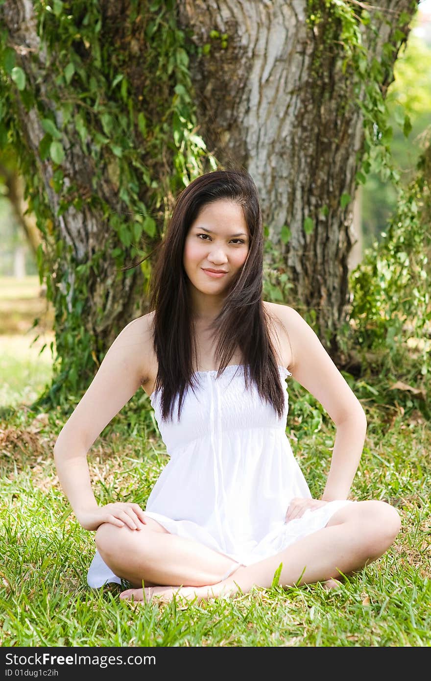 A beautiful asian girl enjoying the outdoor sun. A beautiful asian girl enjoying the outdoor sun