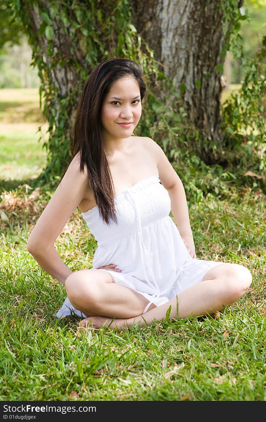 A beautiful asian girl enjoying the outdoor sun. A beautiful asian girl enjoying the outdoor sun