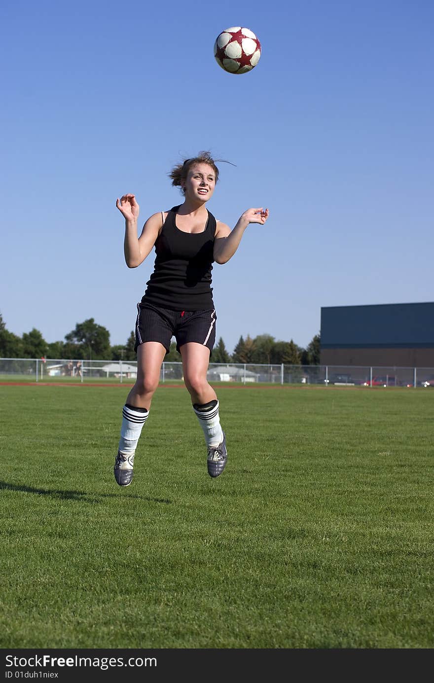 Playing soccer outside on beautiful summer day. Playing soccer outside on beautiful summer day