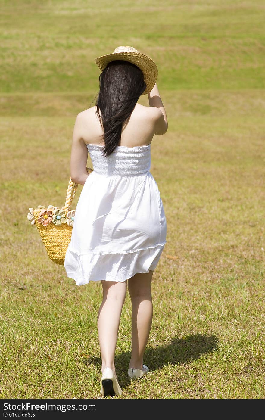 A beautiful asian girl enjoying the outdoor sun. A beautiful asian girl enjoying the outdoor sun