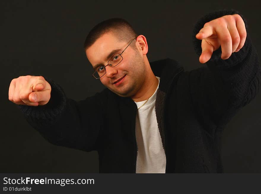 Young relaxed casual man pointing with his finger