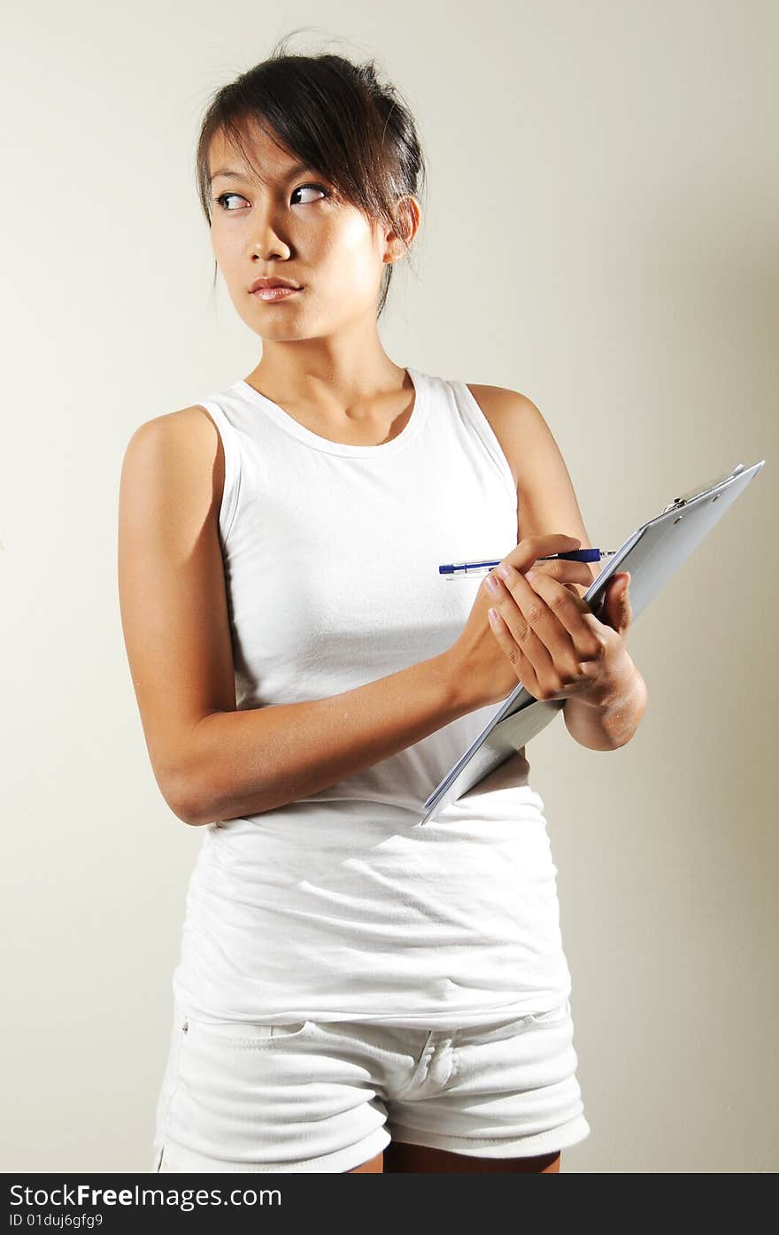 Sports Woman Making A Note On Clipboard