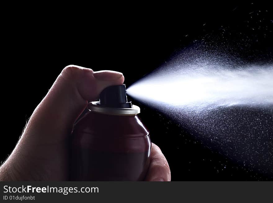 Deodorant in hand isolated on black