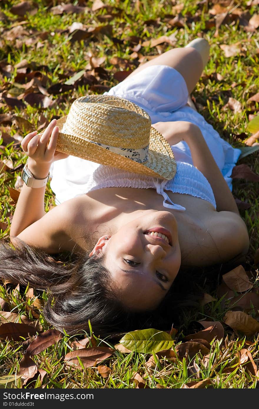 A beautiful asian girl enjoying the outdoor sun. A beautiful asian girl enjoying the outdoor sun