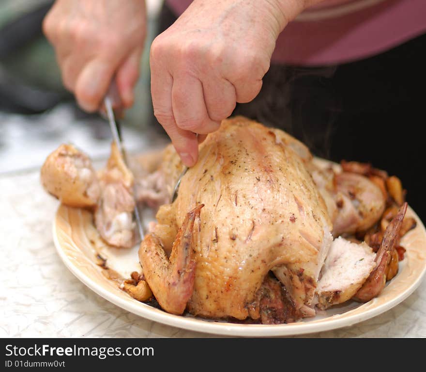 Woman parts fried chicken by knife