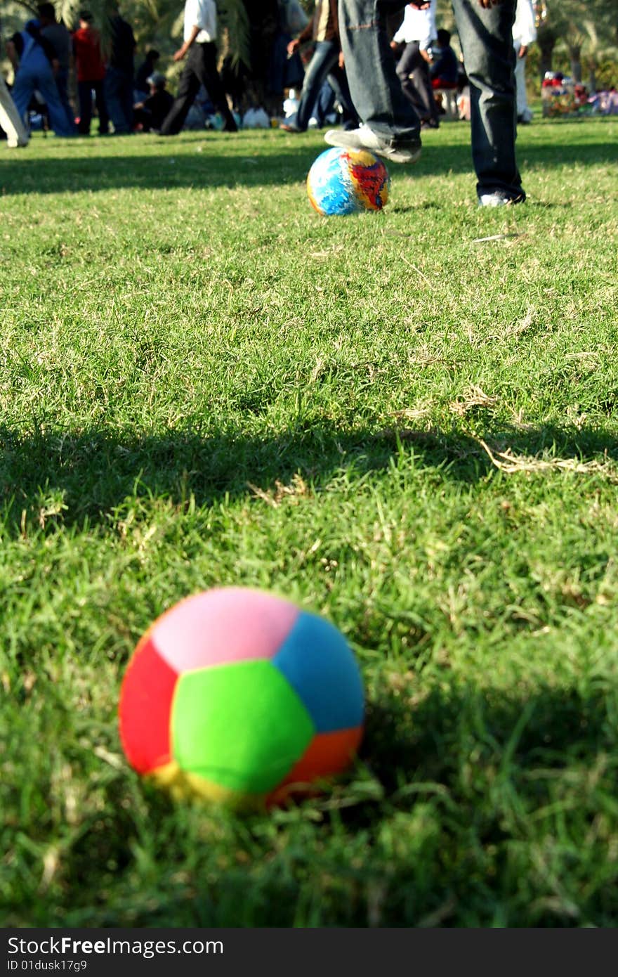 Colourful ball on the grass in a park. Colourful ball on the grass in a park