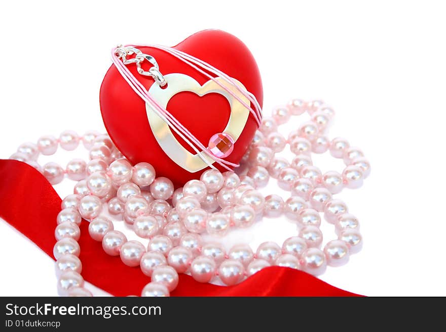 Valentine hearts,red ribbon and pink pearls on white background.