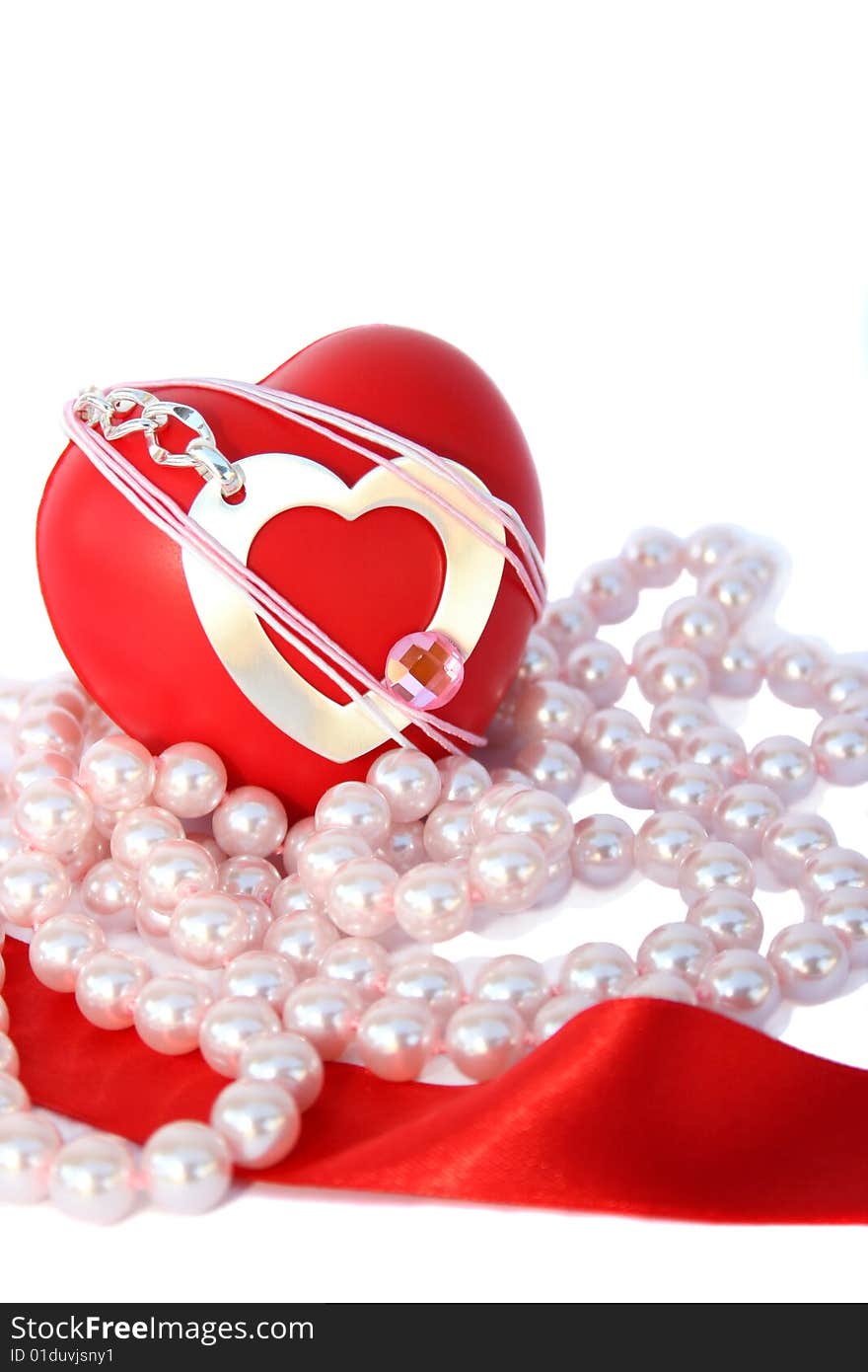 Valentine hearts,red ribbon,pink pearls on white background.