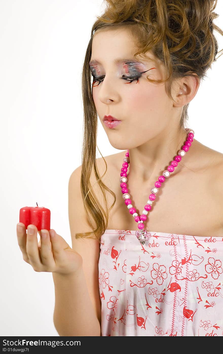 Fashion girl blowing out red heart shaped valentine's day candle. Fashion girl blowing out red heart shaped valentine's day candle