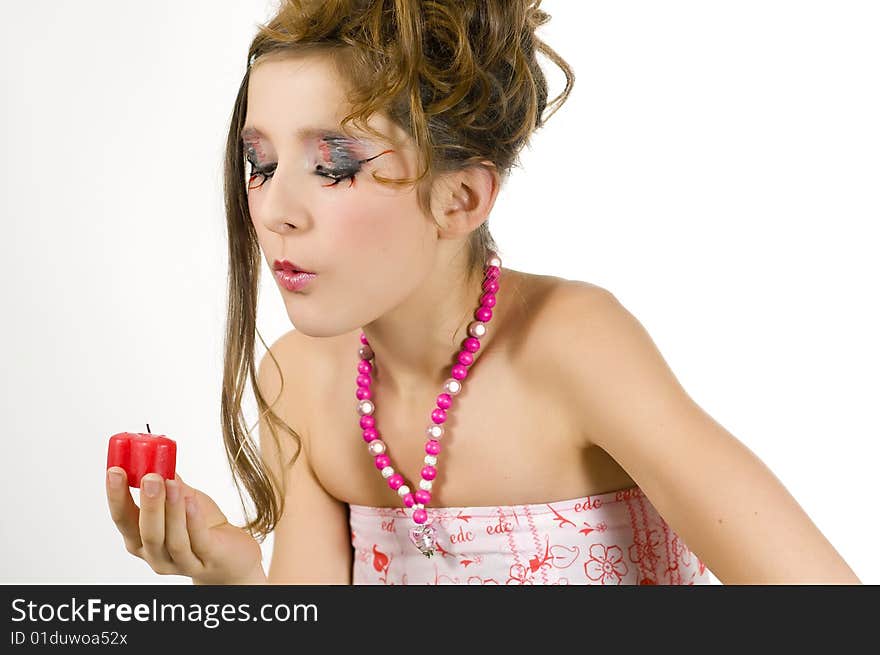 Fashion girl blowing out red heart shaped valentine's day candle. Fashion girl blowing out red heart shaped valentine's day candle