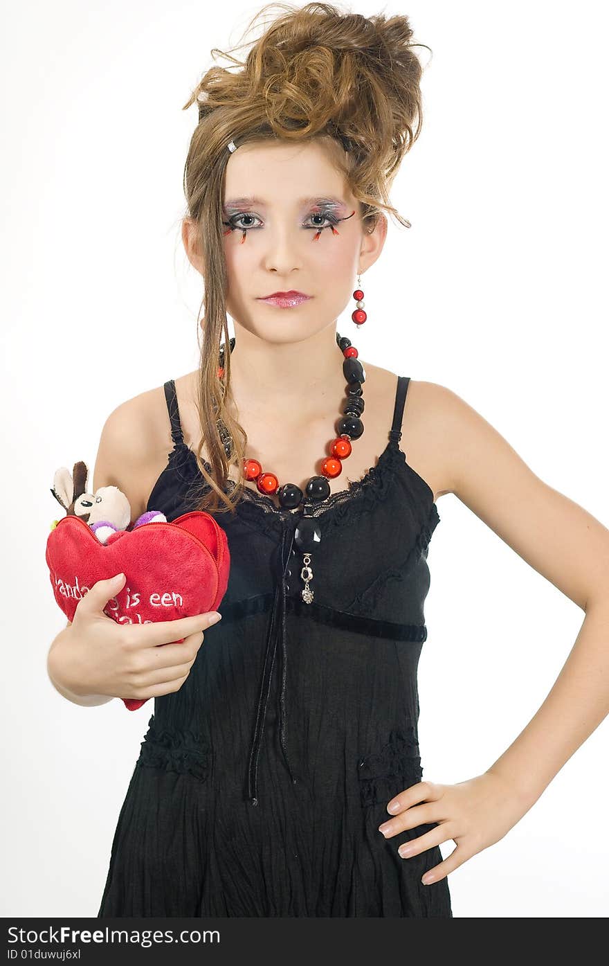 Fashion girl with black red necklace and black top holding a valentine's day present in her hand. Fashion girl with black red necklace and black top holding a valentine's day present in her hand