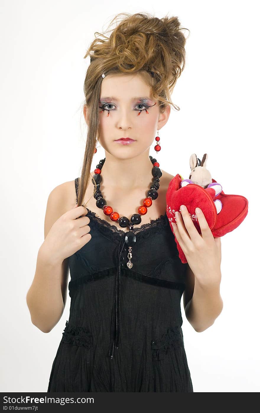 Fashion girl with black red necklace and black top holding a valentine's day present in her hand. Fashion girl with black red necklace and black top holding a valentine's day present in her hand