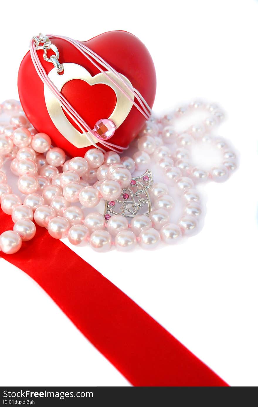 Valentine hearts,red ribbon and pink pearls on white background.