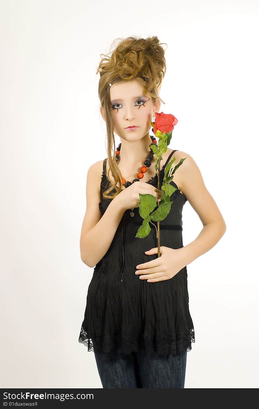 Fashion girl with black red necklace and black top holding a valentine's day red rose in her hand. Fashion girl with black red necklace and black top holding a valentine's day red rose in her hand