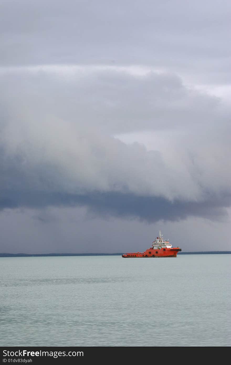 Tug boat heading out into a storm. Tug boat heading out into a storm.