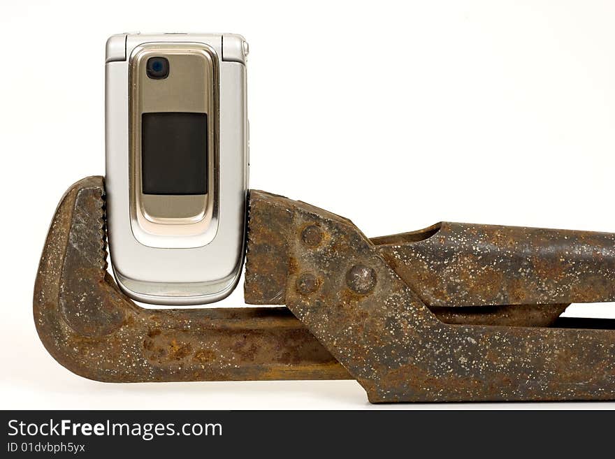 Old rusty nut key and modern telephone on a white background. Old rusty nut key and modern telephone on a white background.