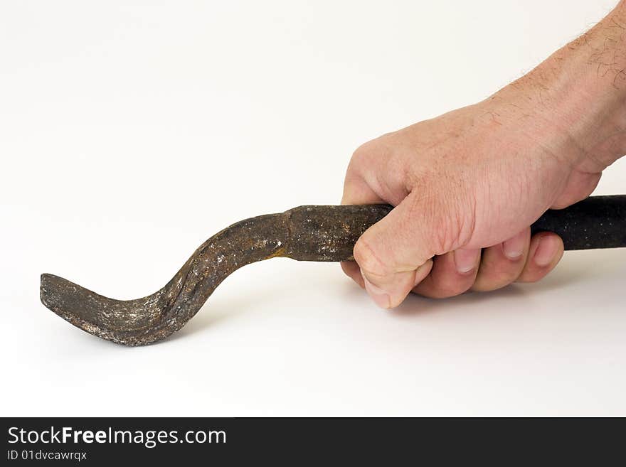 The iron tool in a hand on a white background. The iron tool in a hand on a white background.