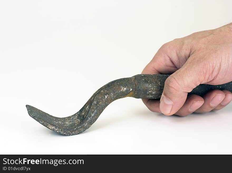 The iron tool in a hand on a white background. The iron tool in a hand on a white background.