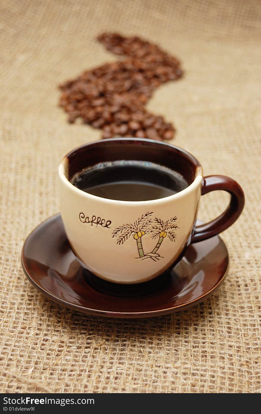 Coffee cup and beans in shape of steam