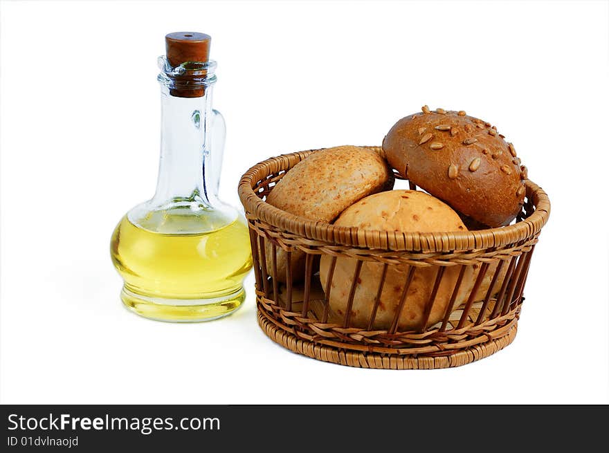 Isolated bottle oil and bread buns basket. Isolated bottle oil and bread buns basket