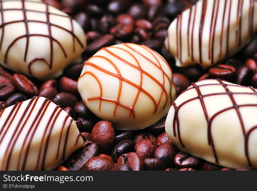 Chocolates on a stack of coffee beans background