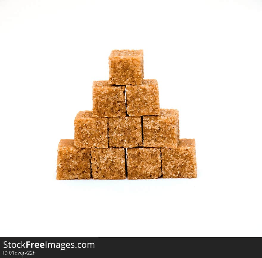 Pyramid of brown sugar cubes isolated on white background. Pyramid of brown sugar cubes isolated on white background