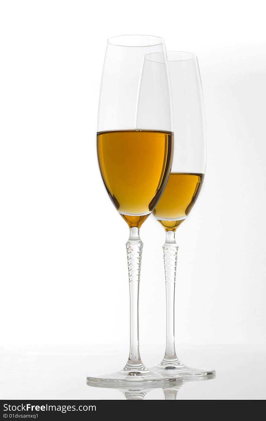 Two glasses of white wine on white background