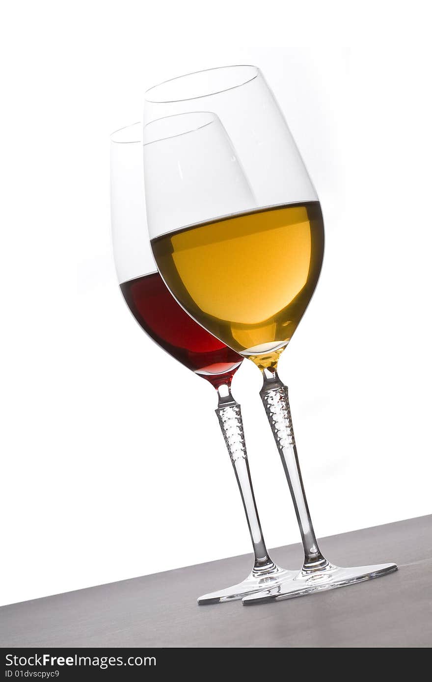 Two glasses of red and white wine on white background