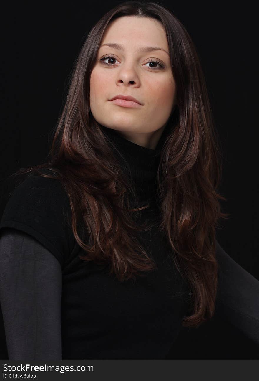 Young brunette on a black background. Young brunette on a black background