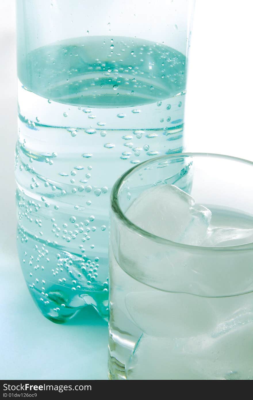 Plastic bottle and glass with pure water.