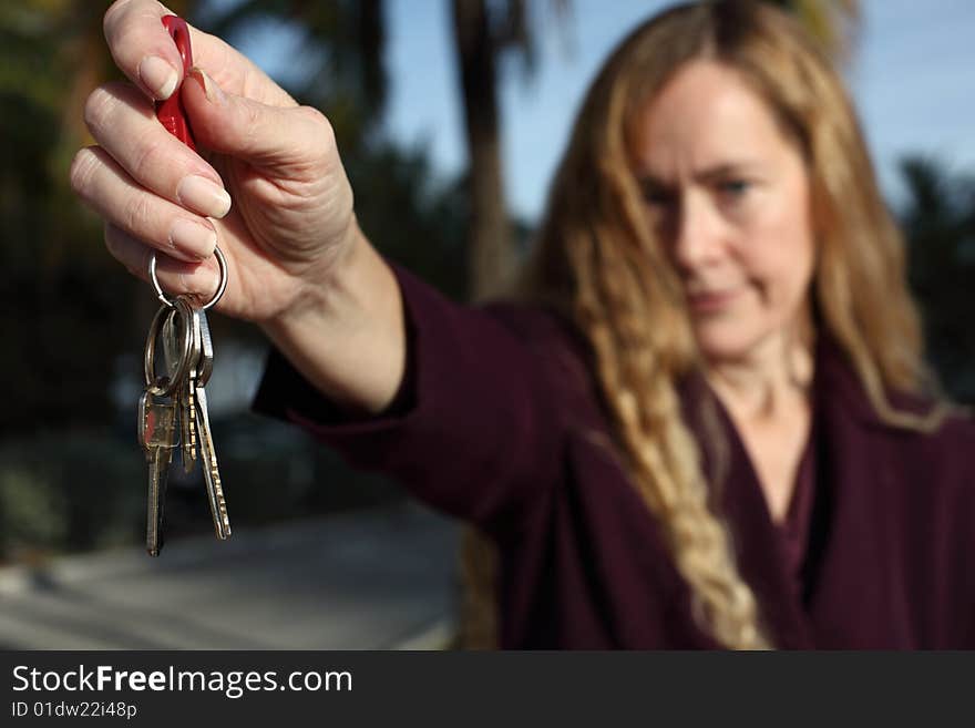 Woman holding out a set of keys. Woman holding out a set of keys