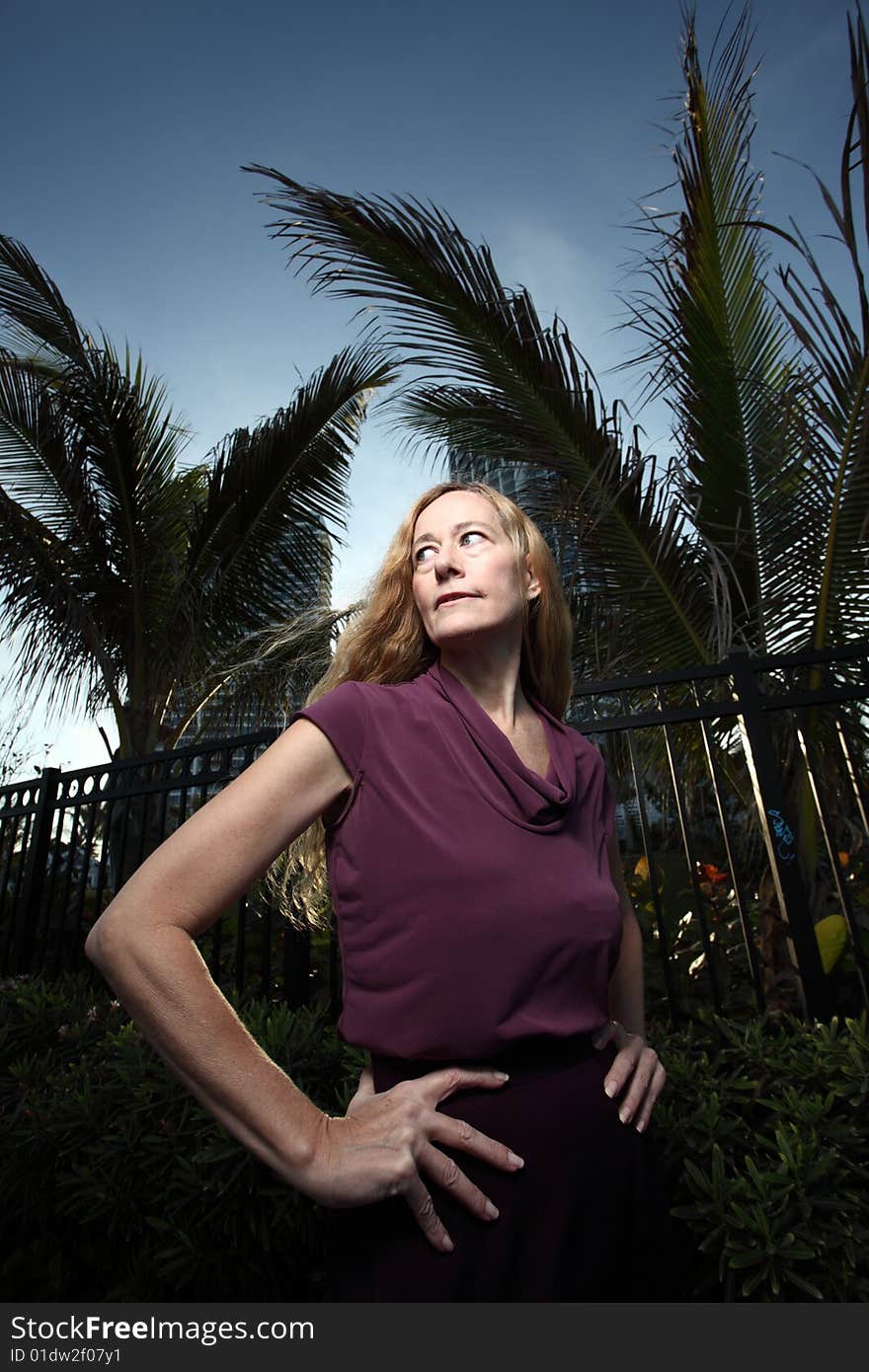 Mature woman posing outside during dusk. Mature woman posing outside during dusk