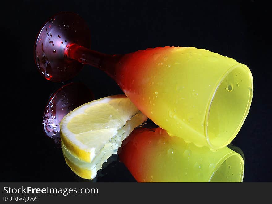 The overturned wine glass on a black background. The overturned wine glass on a black background