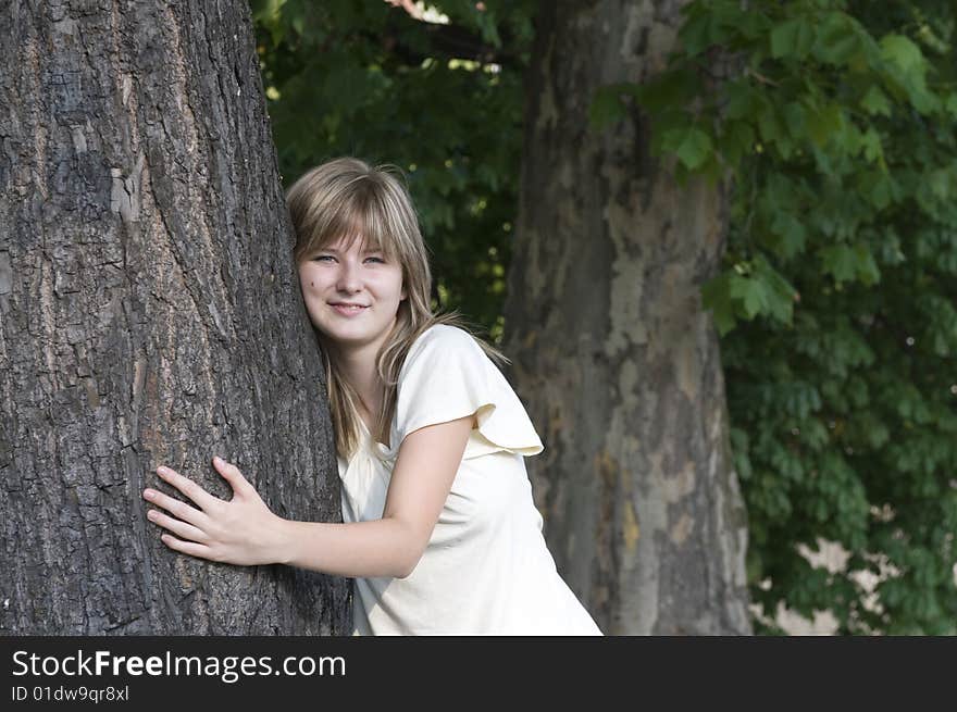 Teenager and trunk of the tree