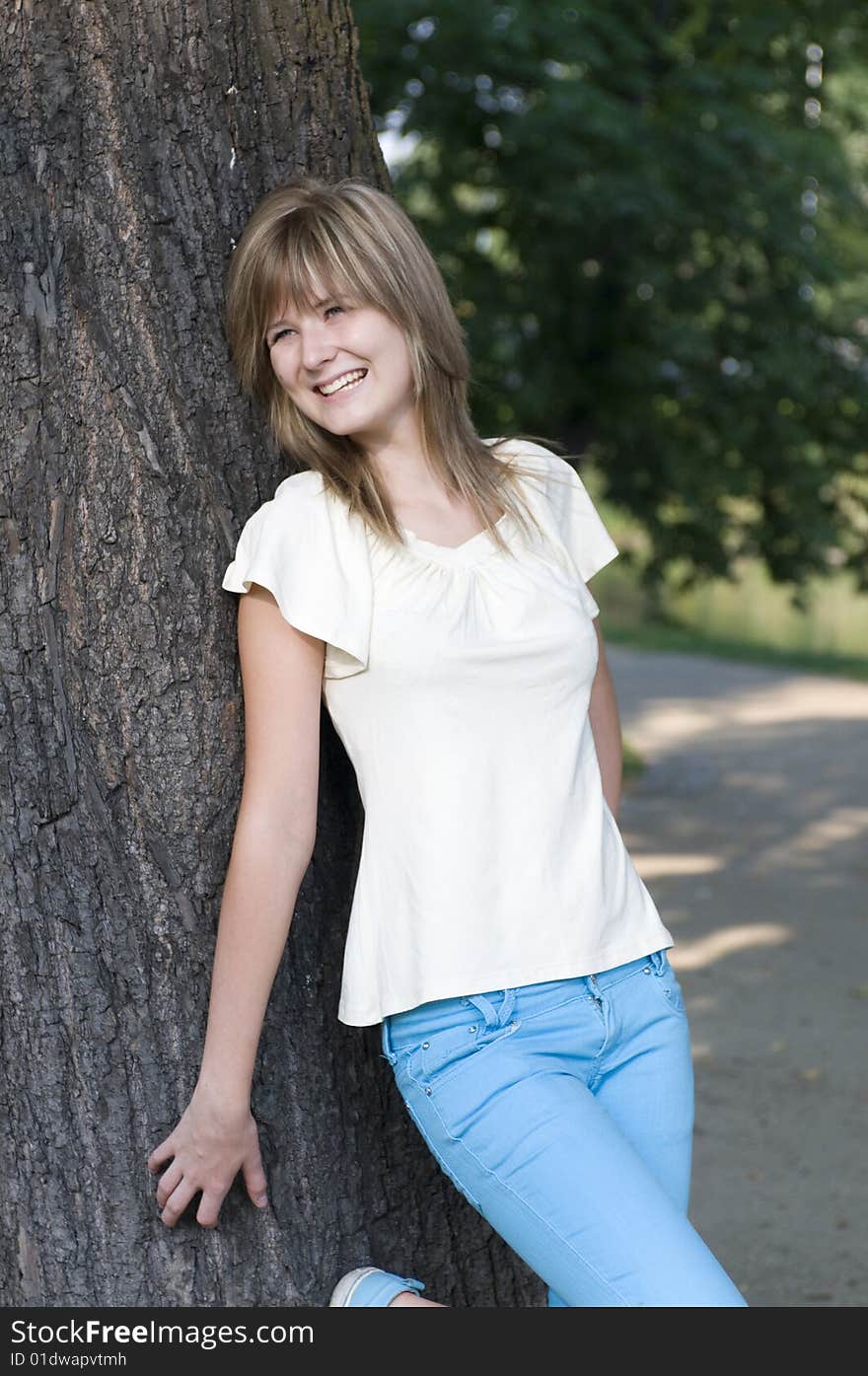 Teenager and trunk of the tree