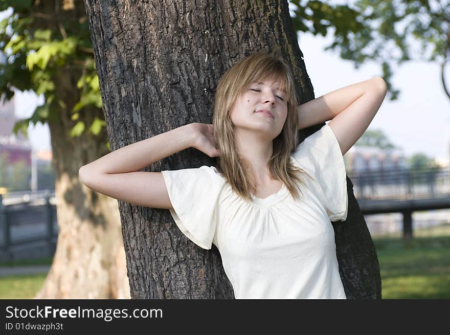 Teenager and trunk of the tree