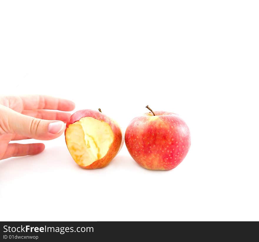 The hand reaches for a delightful red apple. The hand reaches for a delightful red apple