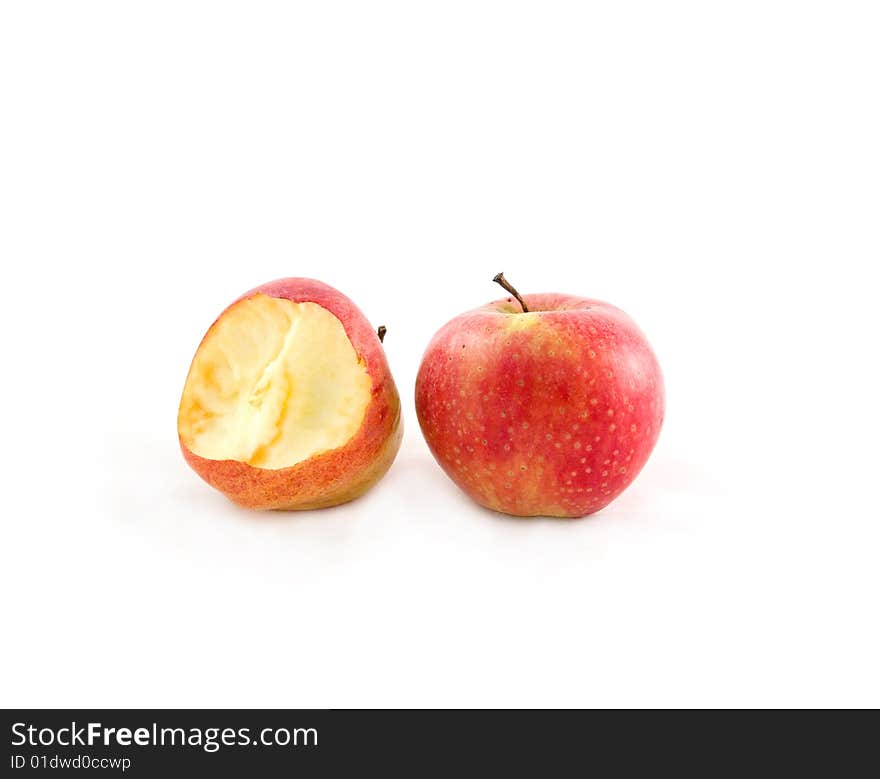 Two delightful ripe apples on the white background, one is bitten. Two delightful ripe apples on the white background, one is bitten