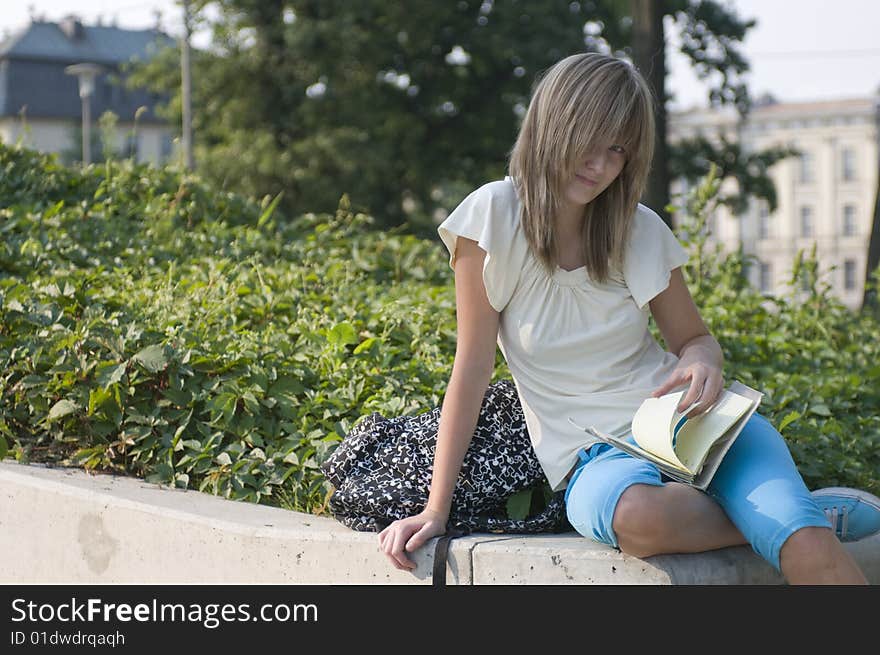 Teenager looks through notes in the park